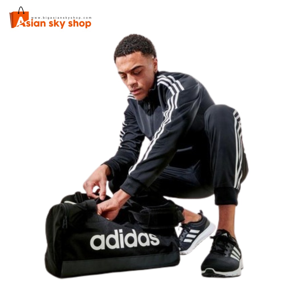 Person carrying Adidas Fitness Gym Bag during workout